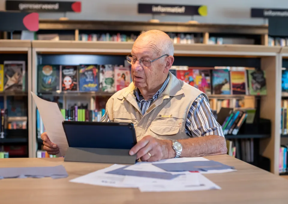 Man achter laptop met belastingenvelop