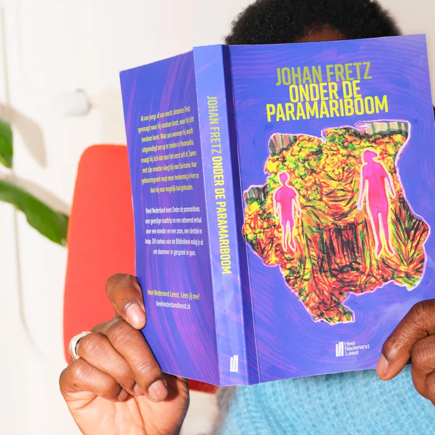 Iemand die het boek onder de paramariboom leest